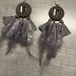 Gray feather earrings with three rows of stones on each earring.